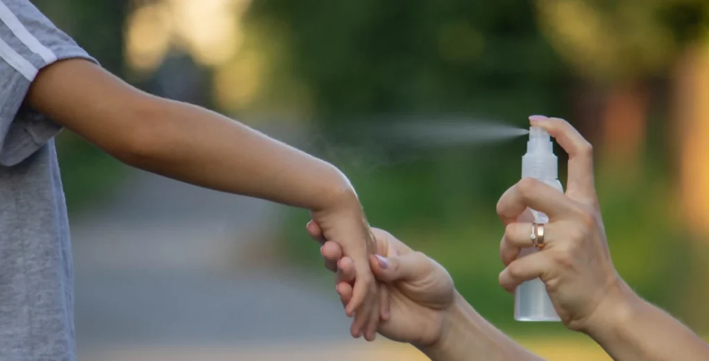 Mosquito Season in Victoria, TX: When It Starts & How to Prepare 3 woman applies insect repellent her sons hand park closeup prevention bites 1